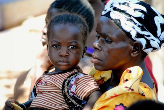 Photo of a mother holding a toddler, Uganda. Photo: Dana Inglehart/JSI
